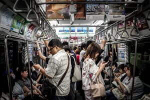 People Standing On The Train In An Orderly Fashion